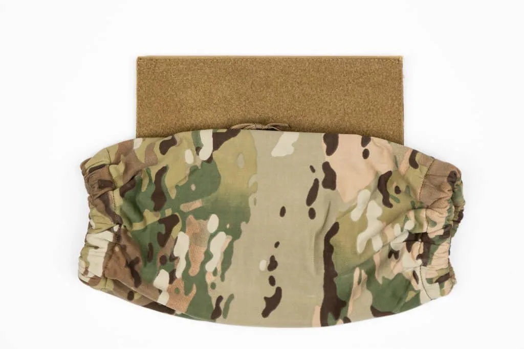 Camouflaged HRT Tactical Hand Warmer with elastic bands on brown rectangular fabric, set against white background.